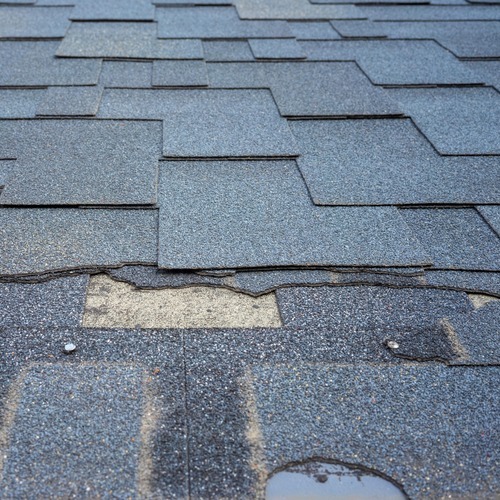 close-up of damaged roofing shingles